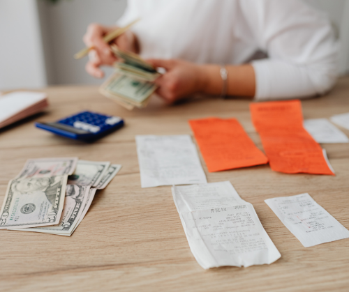 Money, calculator, and bills on tabletop